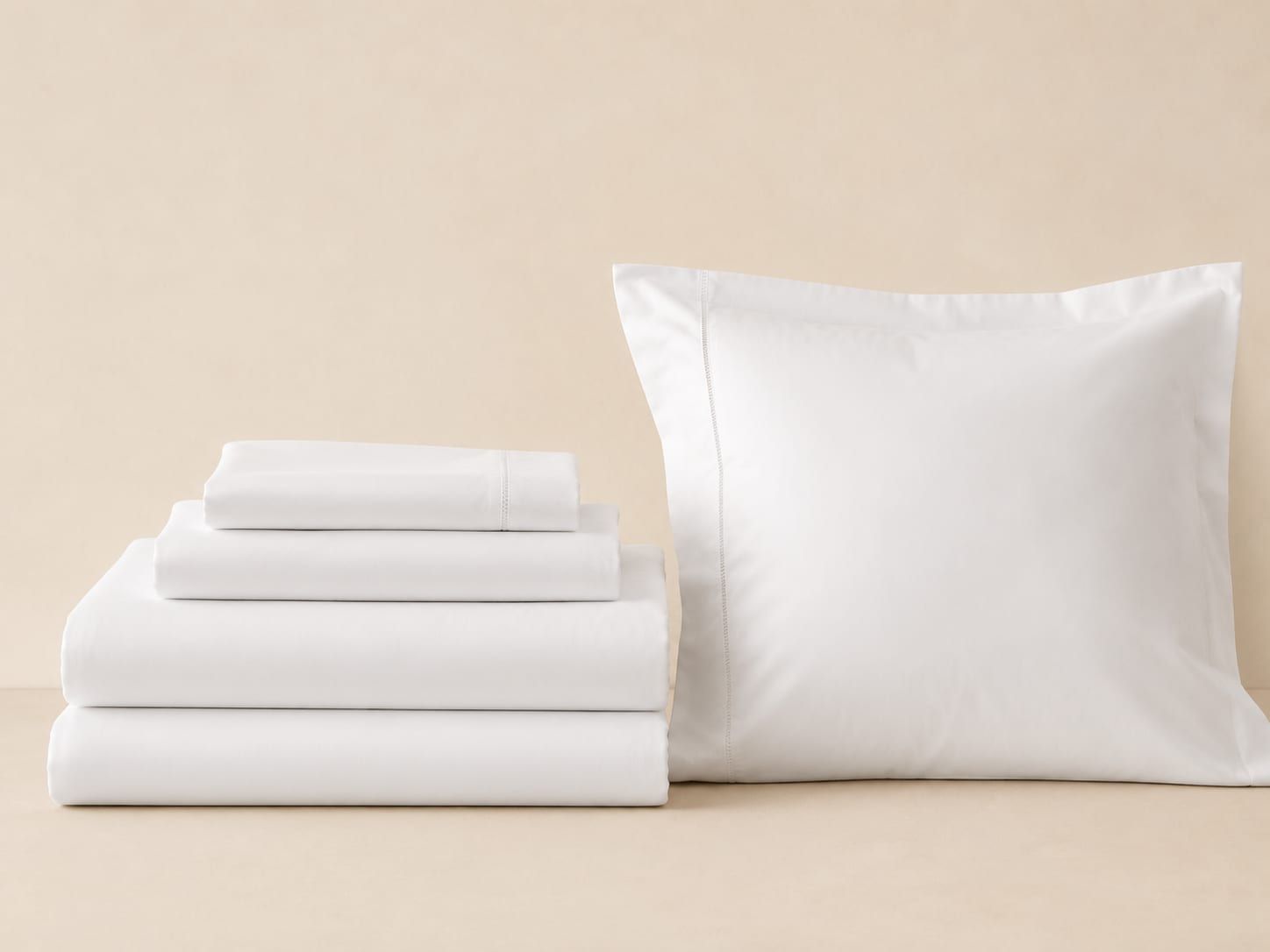 Folded hotel-grade percale sheets representing VIRA Supply